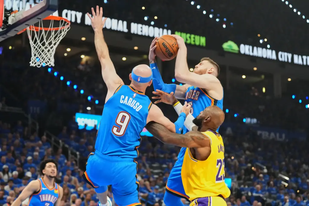 Oklahoma City Thunder center Isaiah Hartenstein, top, comes down with...
