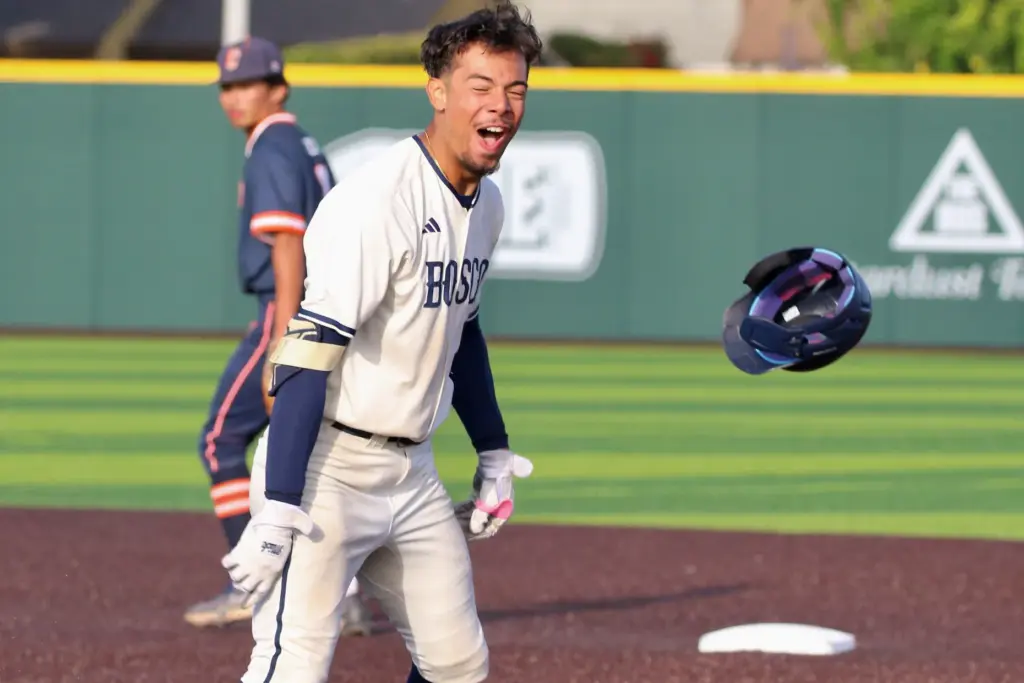 St. John Bosco senior first baseman Moises Razo tosses his...