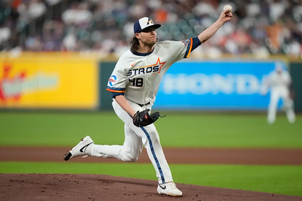 Houston Astros starting pitcher Steven Okert throws to the plate...