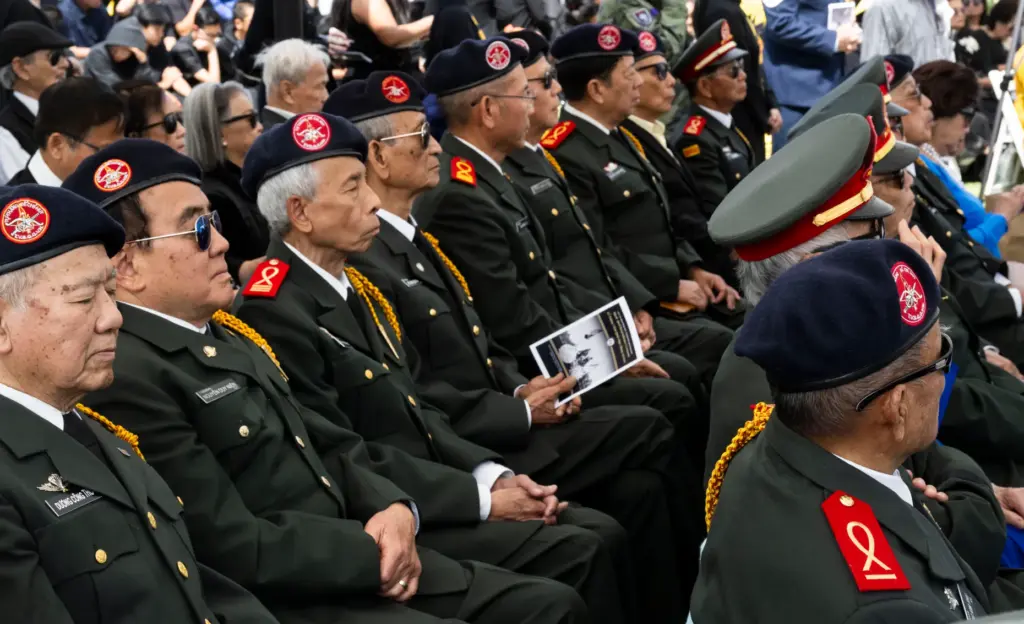 Audience members listen to speakers during a Black April Remembrance...
