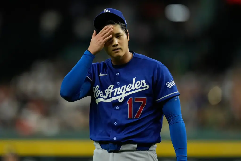 Dodgers starting pitcher Shohei Ohtani walks back to the dugout...