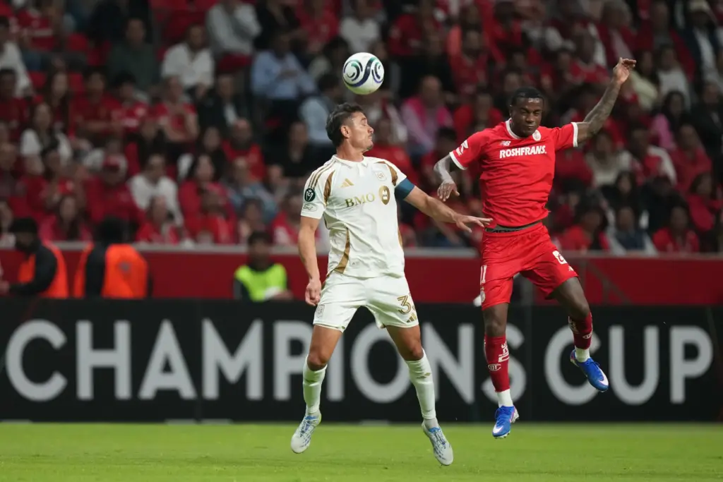 LAFC’s Aaron Long, left, heads the ball in front of...
