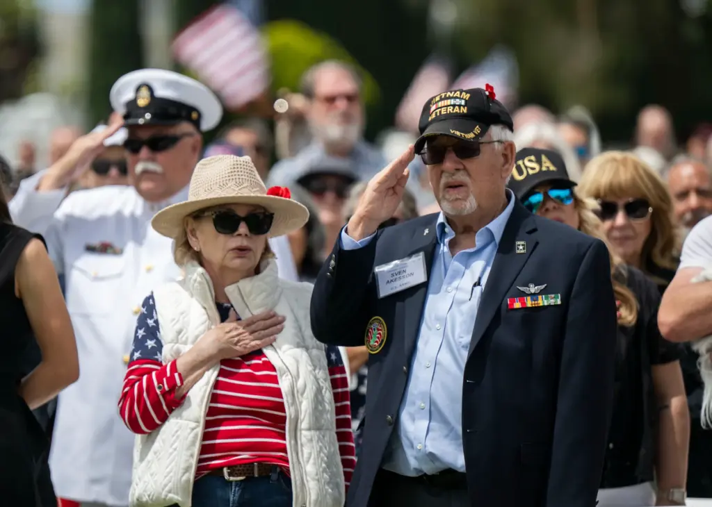 Army veteran Sven Akisson salutes during the National Anthem during...