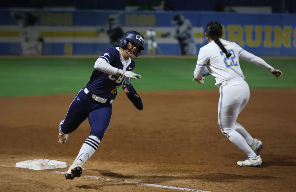 California Baptistâs Makayla Medellin, left, races around third base before...