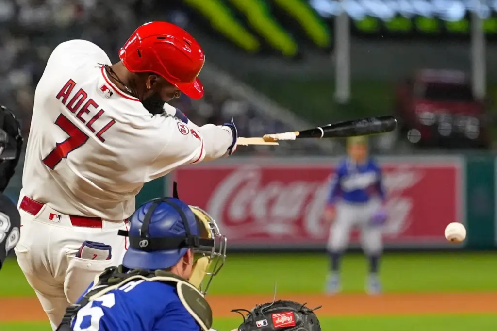 The Angels’ Jo Adell breaks his bat before being thrown...
