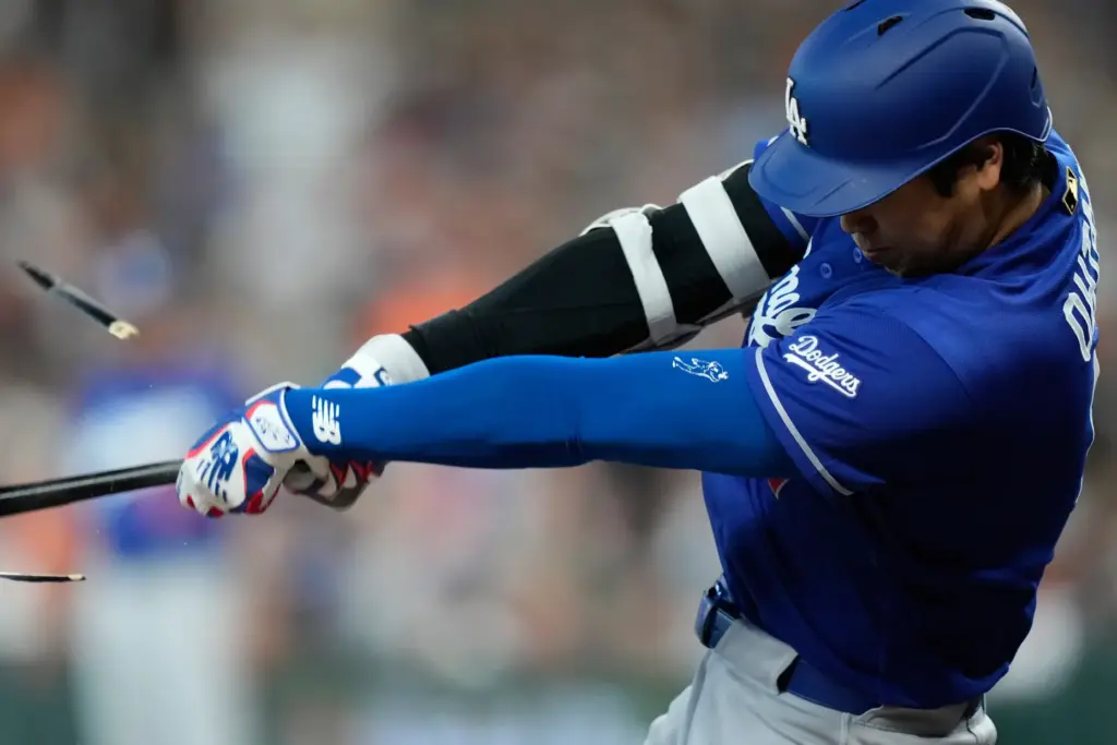 Dodgers designated hitter Shohei Ohtani breaks his bat on a...