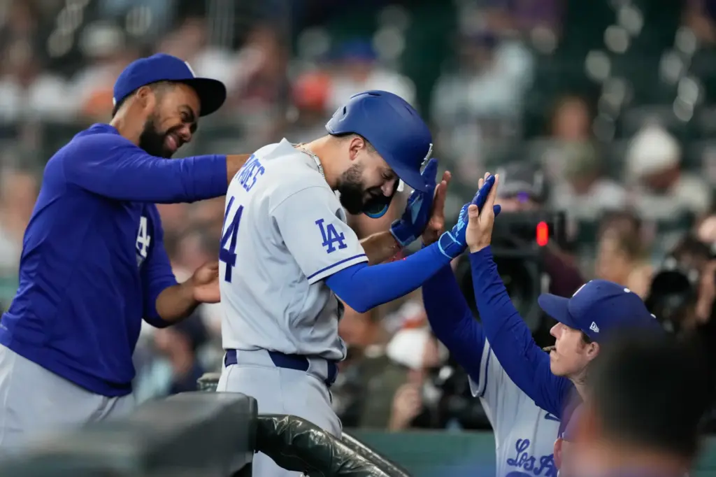 The Dodgers’ Andy Pages, middle, is congratulated as he returns...