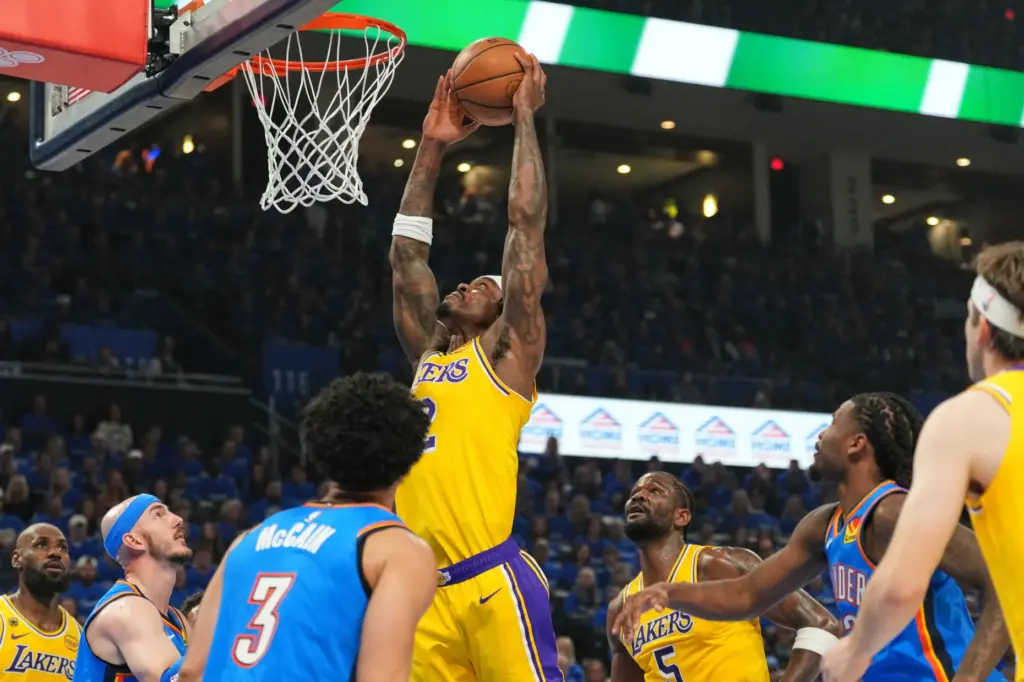 Lakers forward Jarred Vanderbilt, center, goes up for a shot...