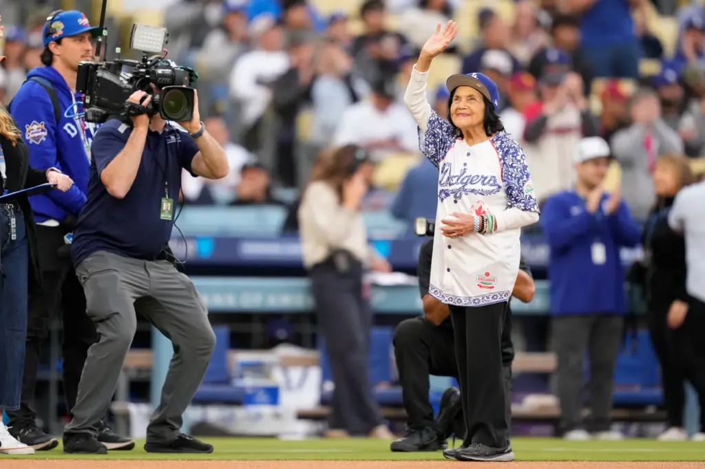 Labor leader Dolores Huerta waves before throwing out the ceremonial...