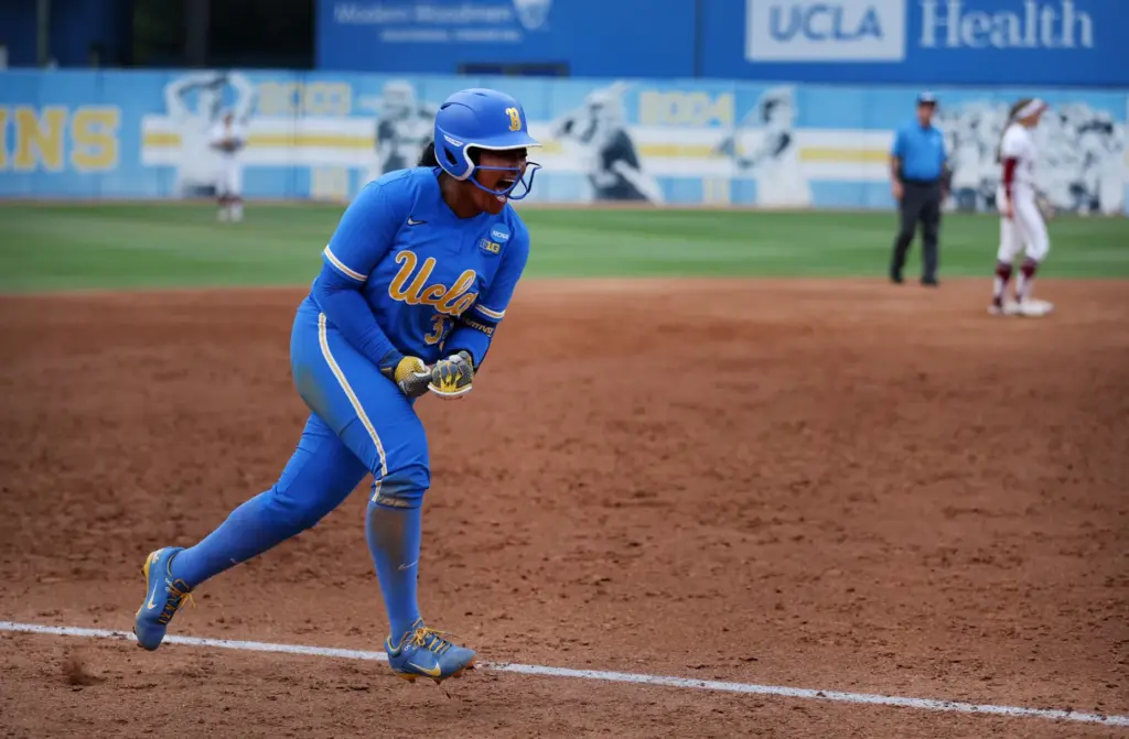UCLAâs Kaniya Bragg (33) celebrates while running along the third...
