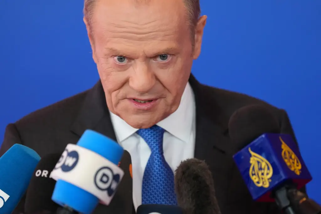 Poland’s Prime Minister Donald Tusk speaks with the media as...