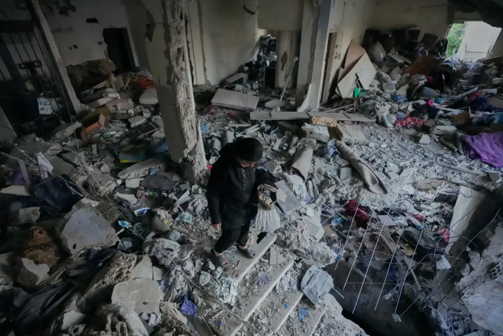 A woman checks a destroyed apartment that was hit in an Israeli airstrike.