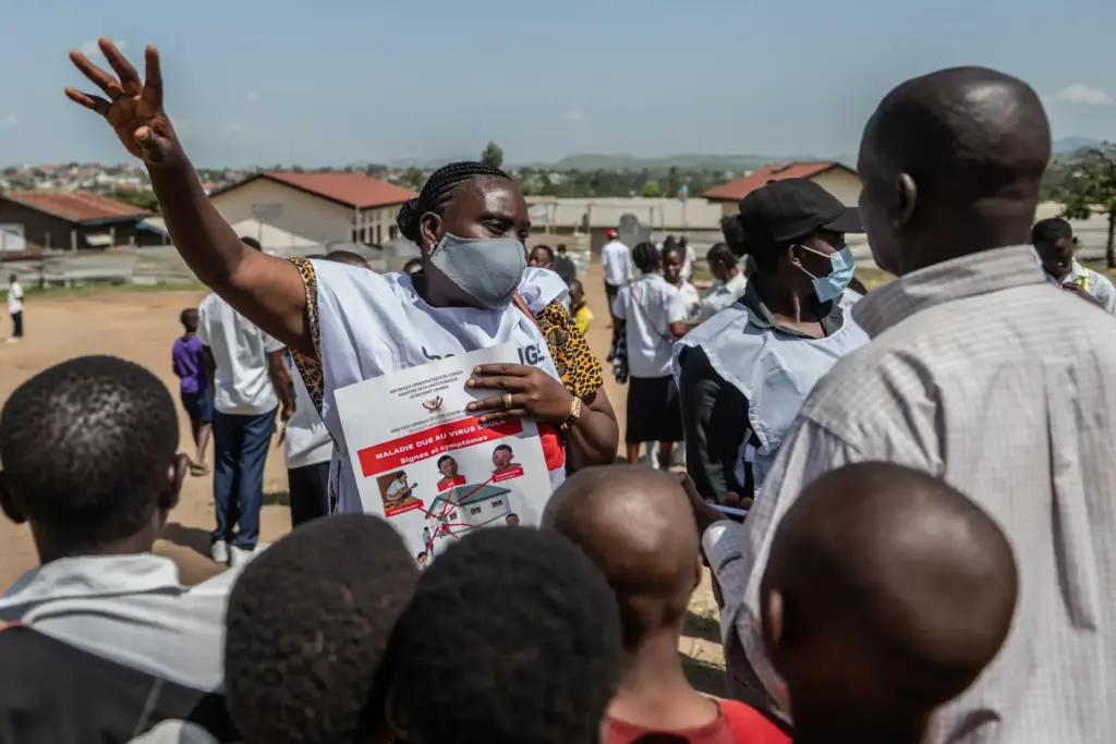 Vanny Birungi, a Red Cross volunteer, speaks to people
