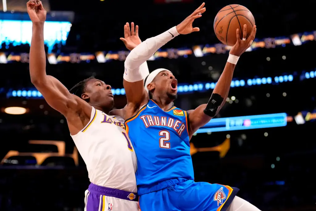 Oklahoma City Thunder guard Shai Gilgeous-Alexander, right, shoots as Lakers...