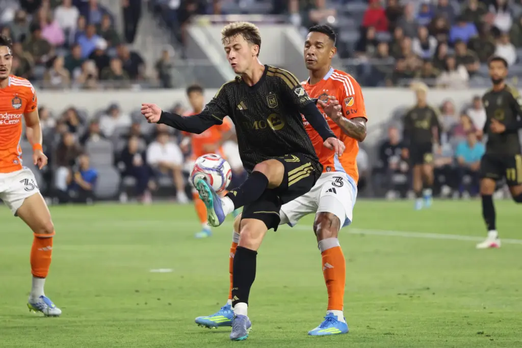LAFC forward Nathan Ordaz, left, recovers the ball defended by...