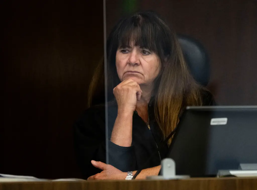 Judge Kimberly Menninger listens to opening statements in court in...