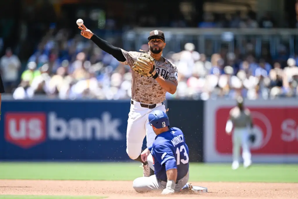 San Diego Padres shortstop Xander Bogaerts, top, throws over Dodgers’...