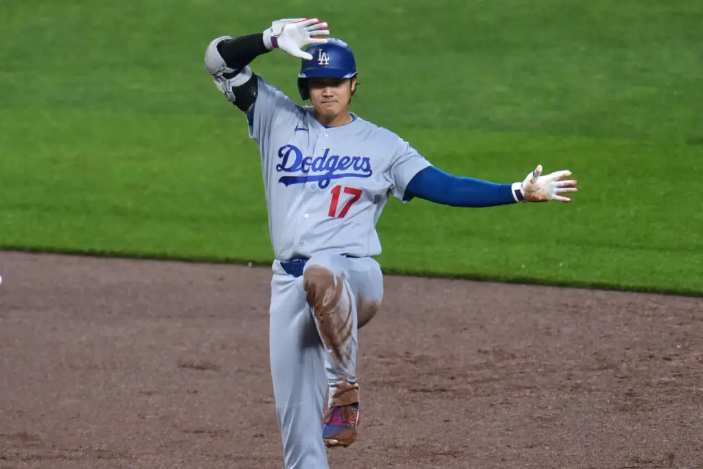 Dodgers star Shohei Ohtani celebrates on second base after driving...