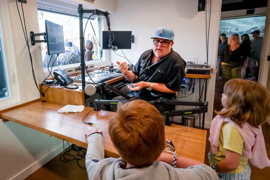 DJ Todd Katsovich answers questions from children at a ribbon-cutting...
