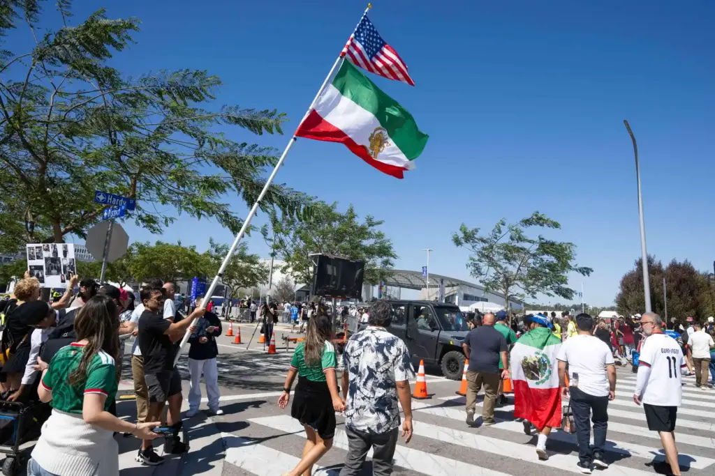 A protester rallies outside SoFi Stadium before the start of...
