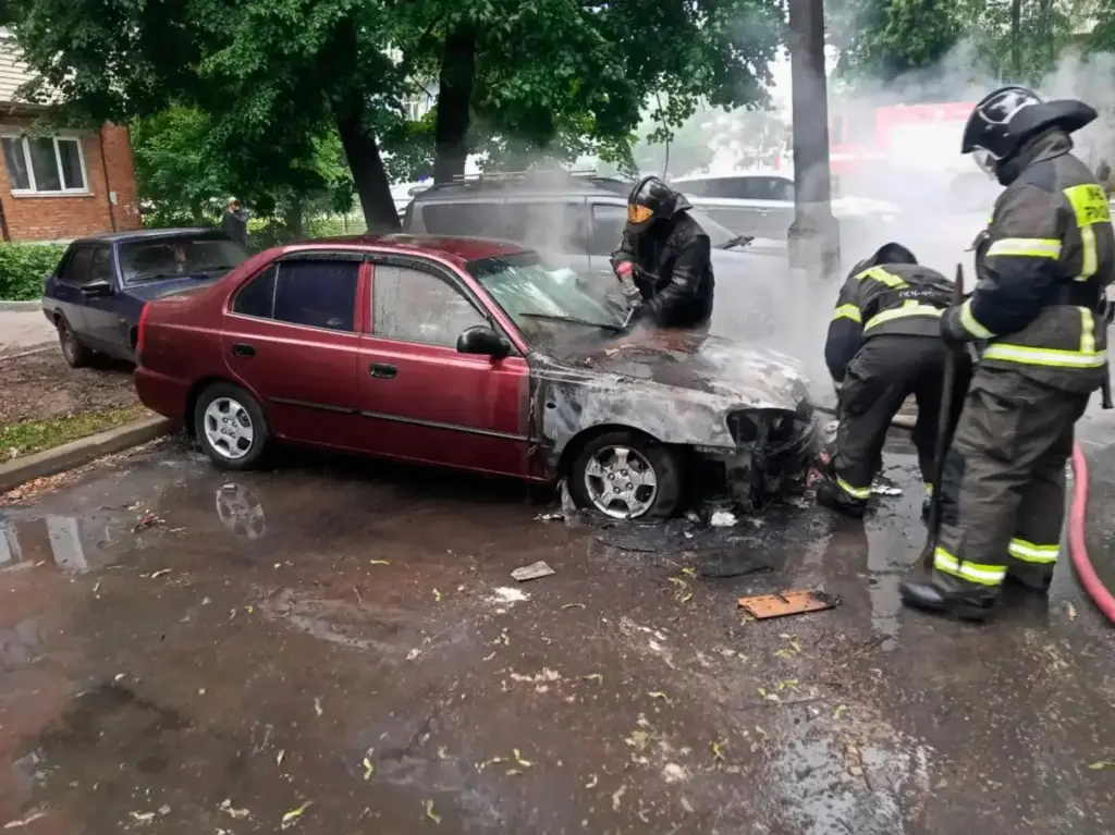Firefighters extinguish a burning car after a Ukrainian drone attack outside Moscow.