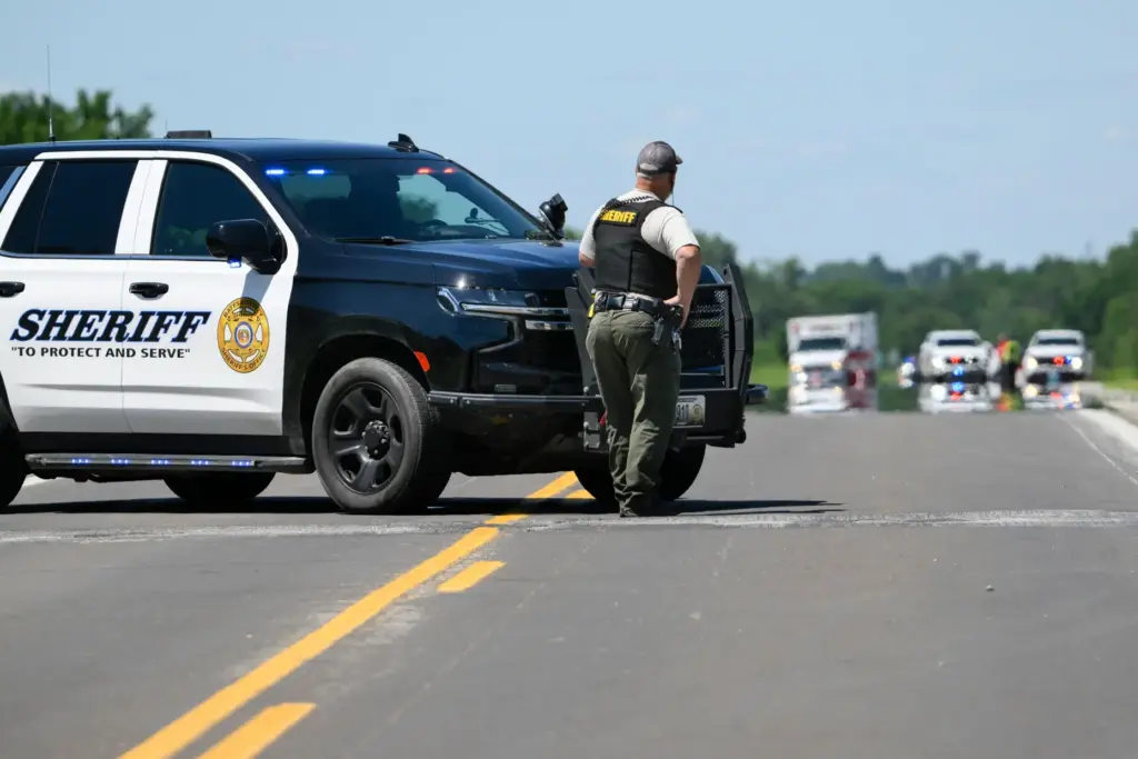 A Bates County Sheriff's deputy mans a roadblock outside the scene of a plane crash.