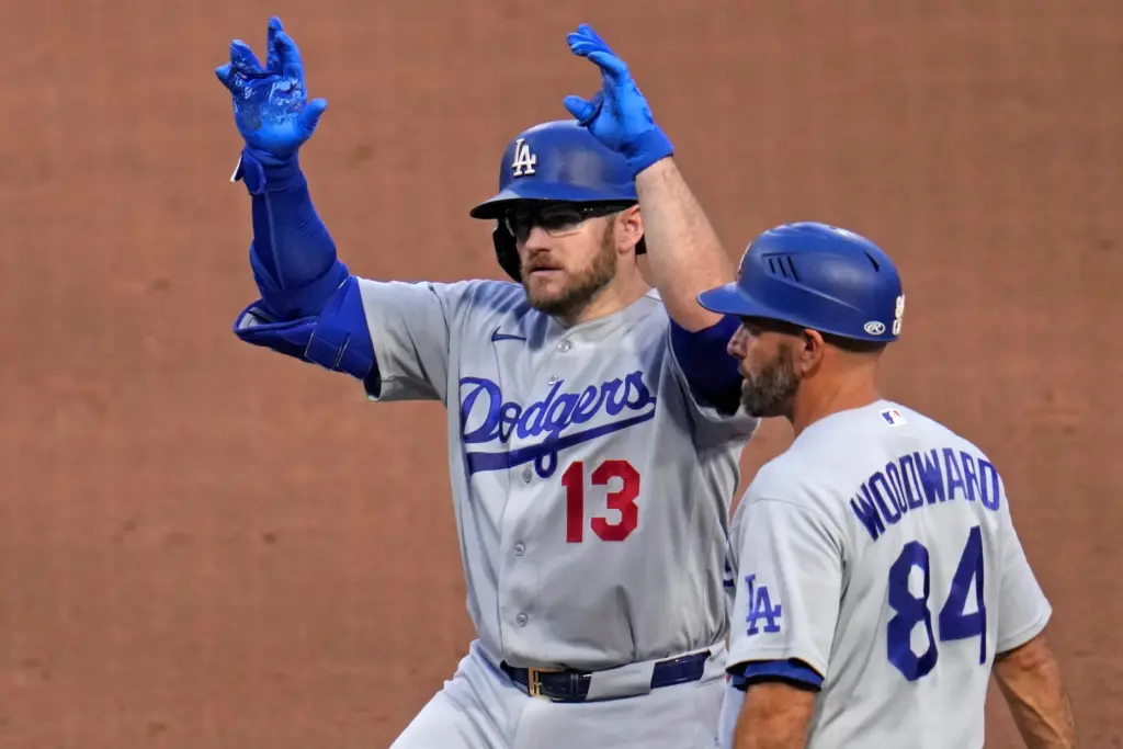 Teh Dodgers’ Max Muncy, left, celebrates as he stands on...