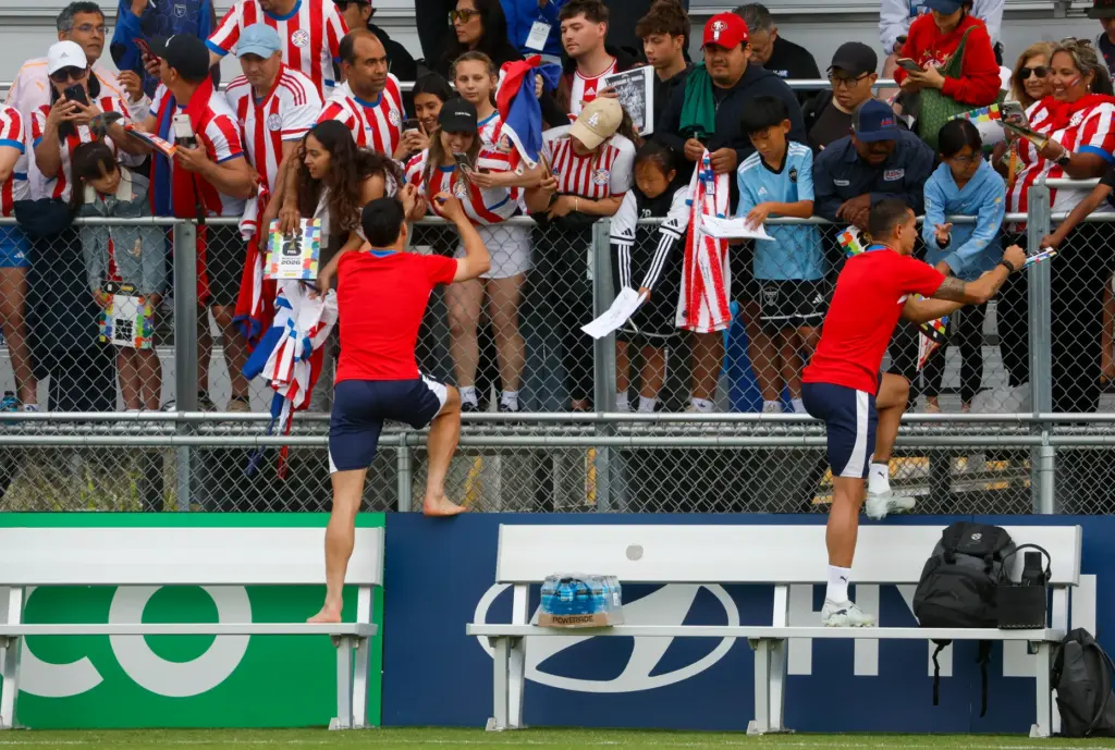 Members of Paraguayâs national soccer team sign autographs after training...