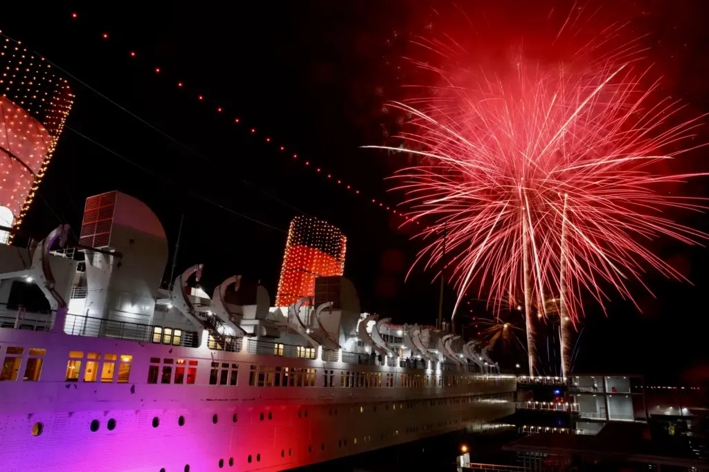 Fireworks light the sky over the Long Beach harbor at...