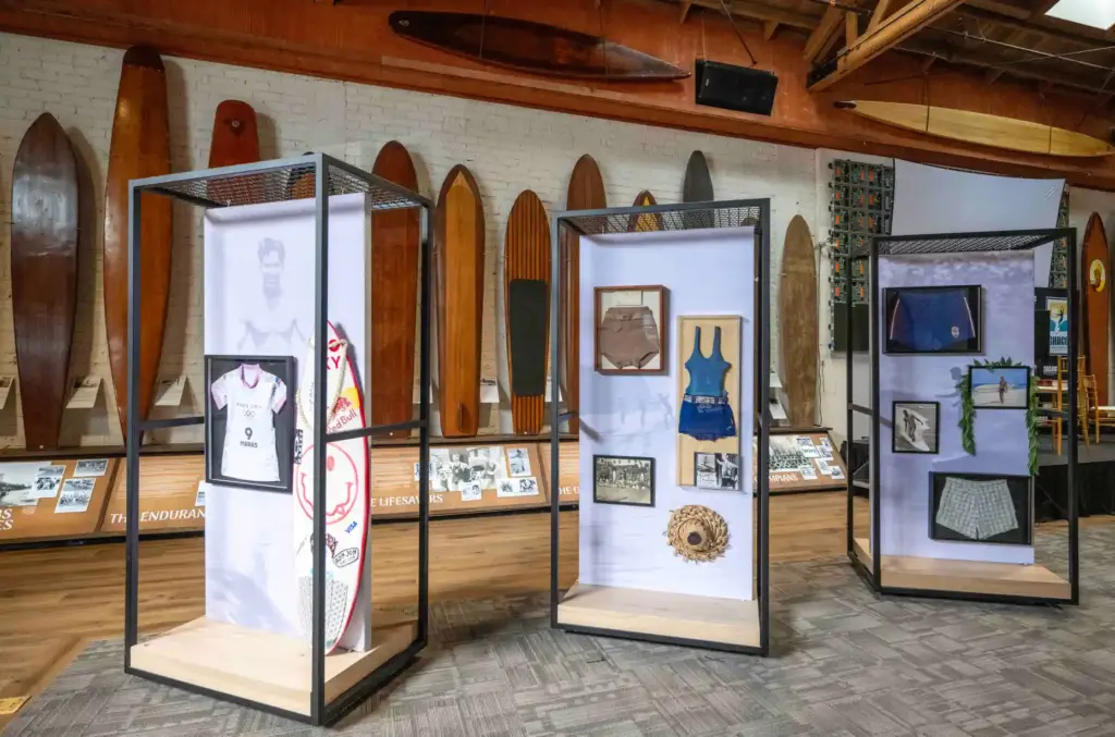 A collection of antique surfboards and other surf memorabilia, including...