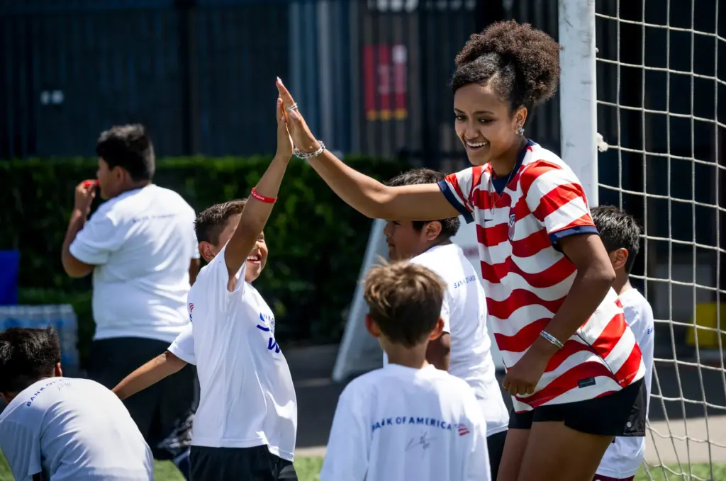 U.S. Womenâs National Team player Lily Yohannes gives high fives...