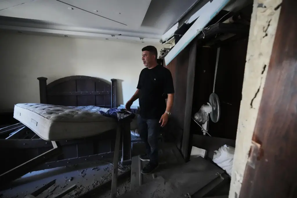 Resident Adnan Kaour inspects his apartment after it was damaged...
