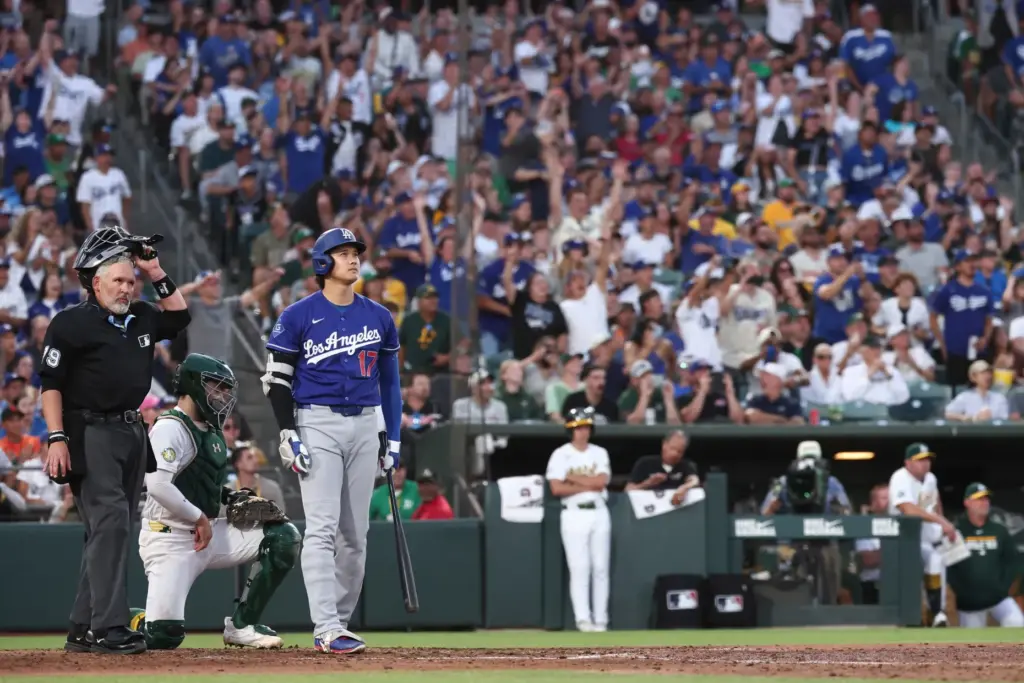 Dodgers star Shohei Ohtani watches the flight of his three-run...
