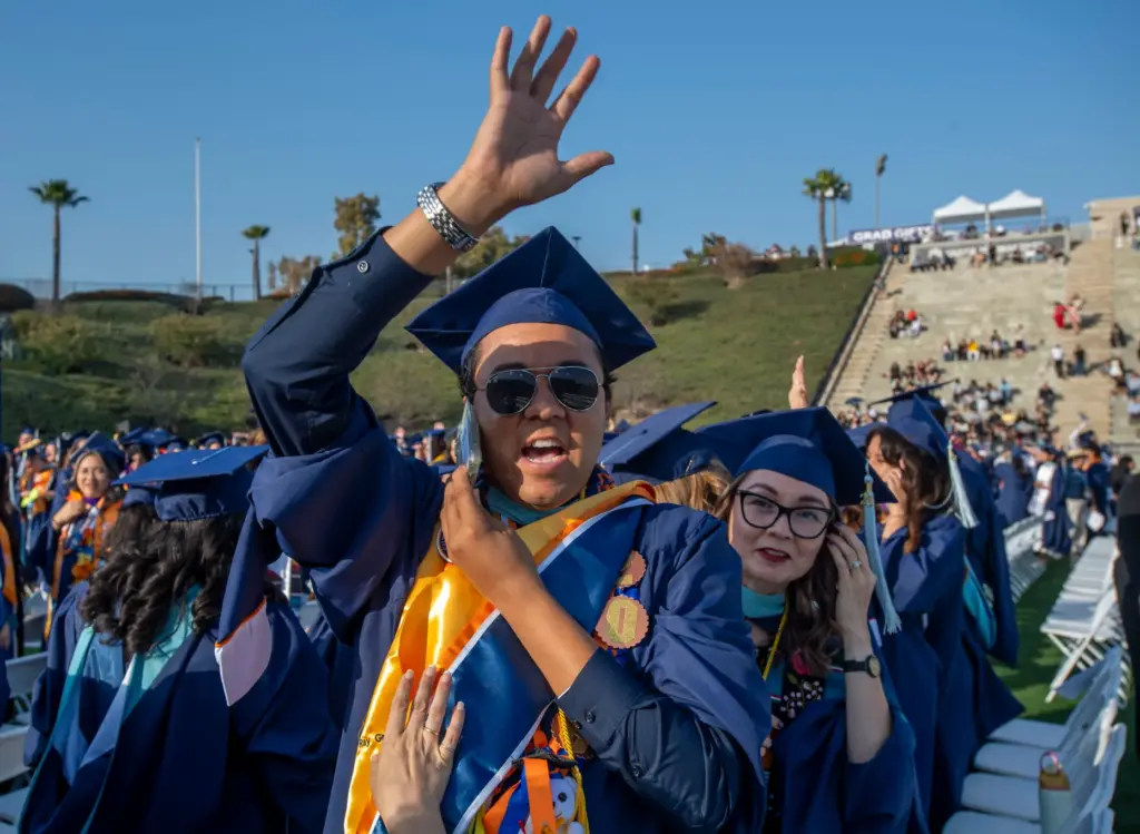 Kevin Greene waves to the audience during CSUF College of...