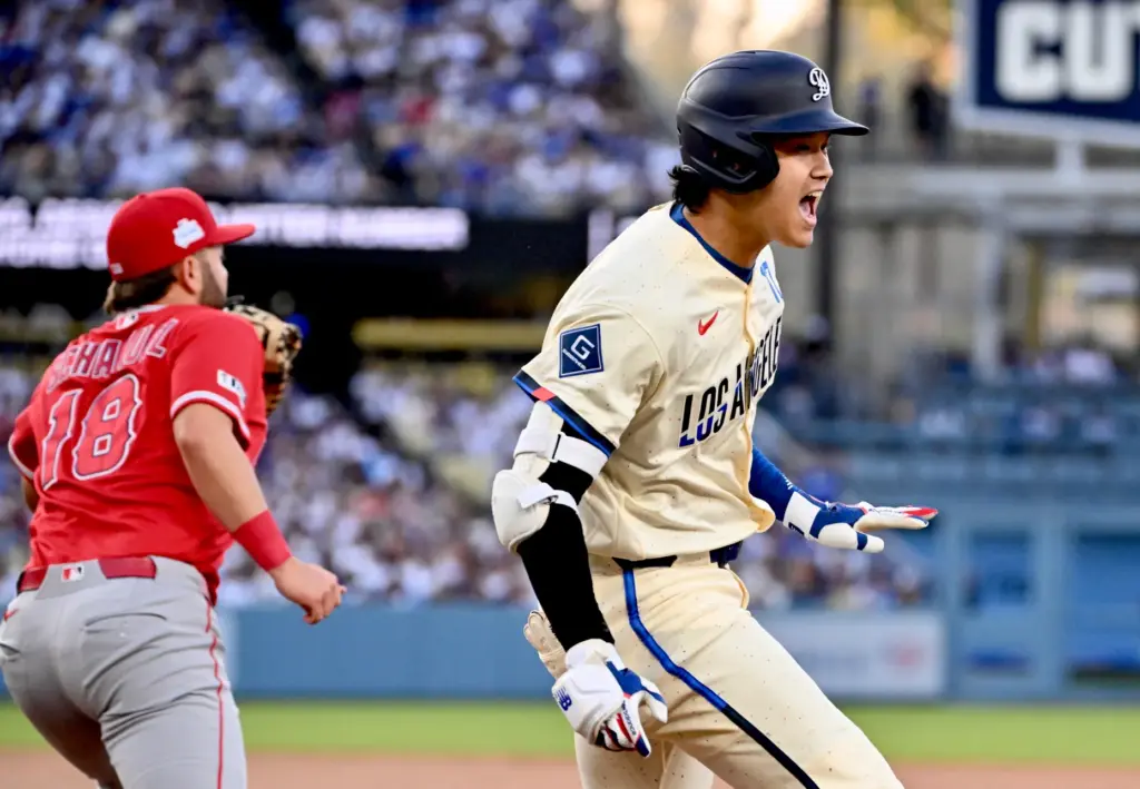 Shohei Ohtani #17 of the Dodgers reacts after a single...
