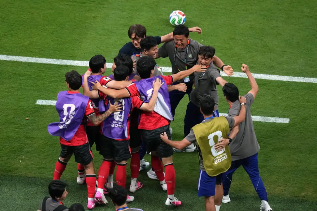 South Korea head coach Hong Myung-bo, top left, celebrates with...