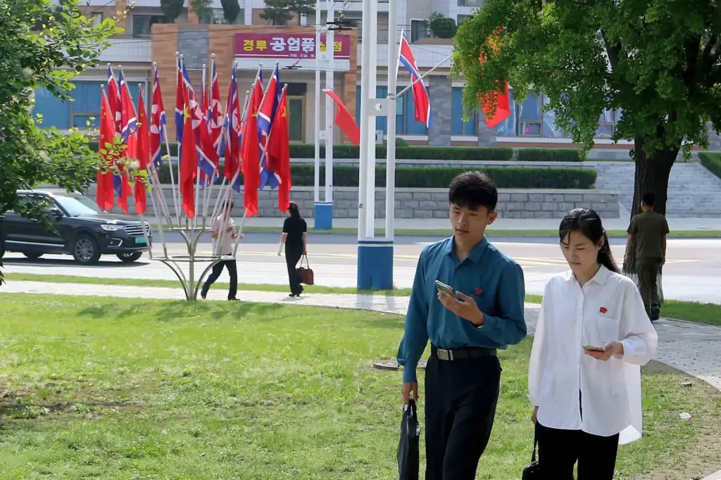 A street is decorated with the flags of China and North Korea in Pyongyang.