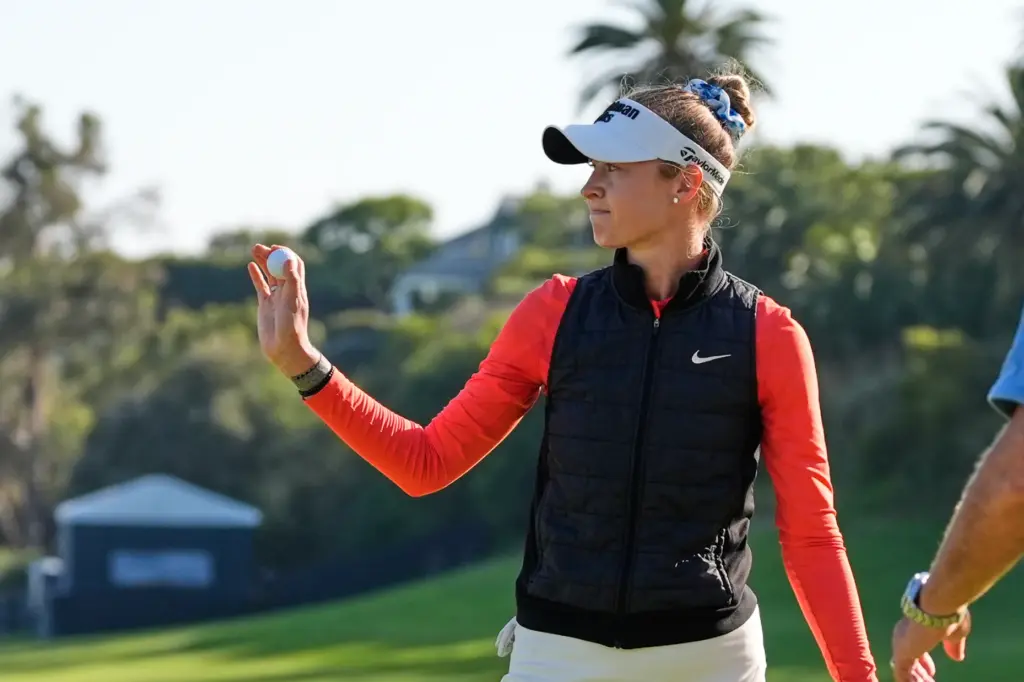 Nelly Korda waves on the 18th green during the third...