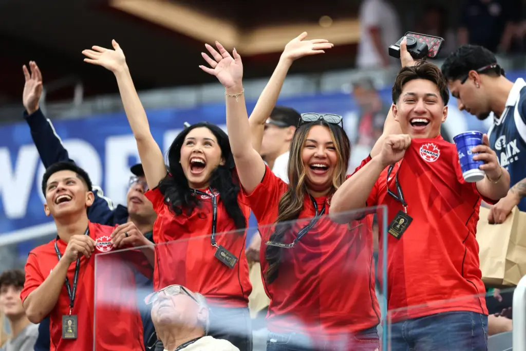 Canada fans react to the camera before the start of...