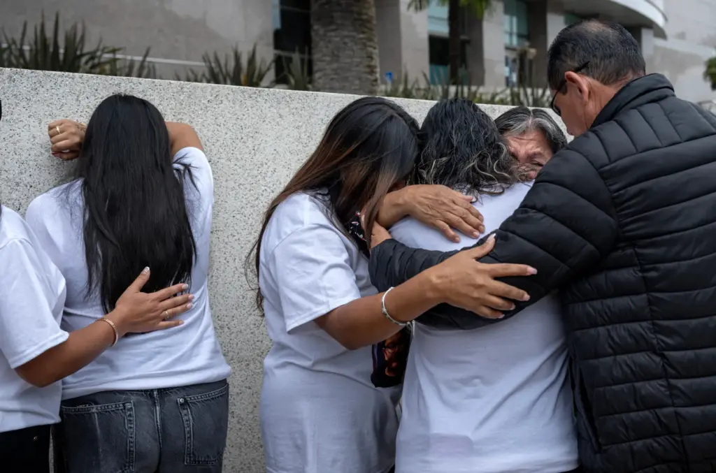 Family members of Jaden Michaca, including his mother, Maribel Michaca, at left with back to camera, embrace after the press conference. (Photo by Mindy Schauer, Orange County Register/SCNG)