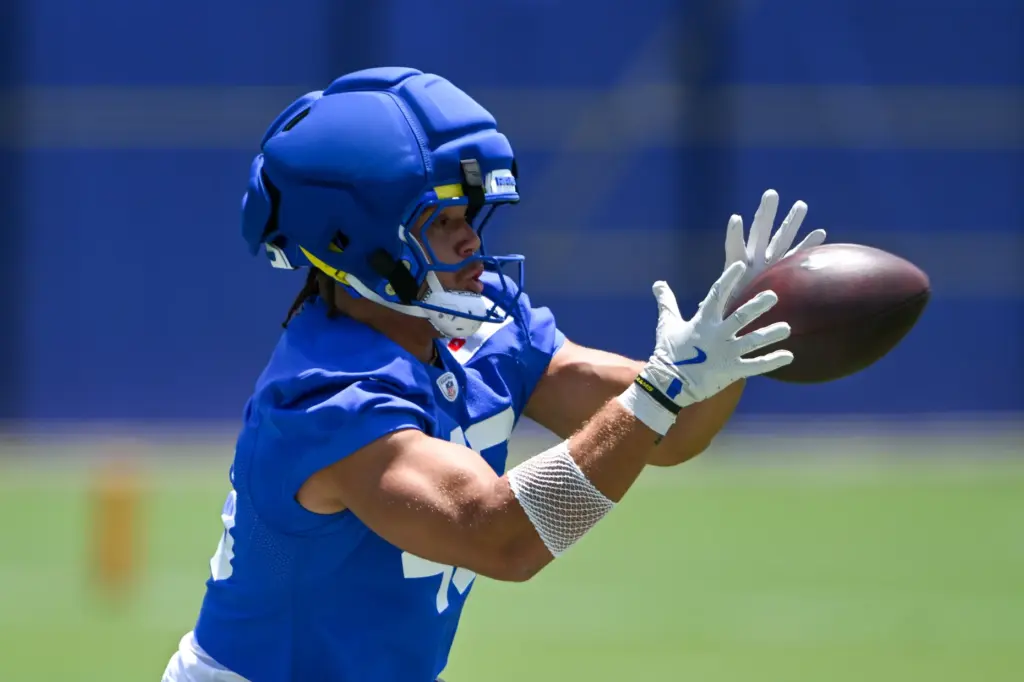 Rams rookie tight end Rohan Jones catches the ball as...