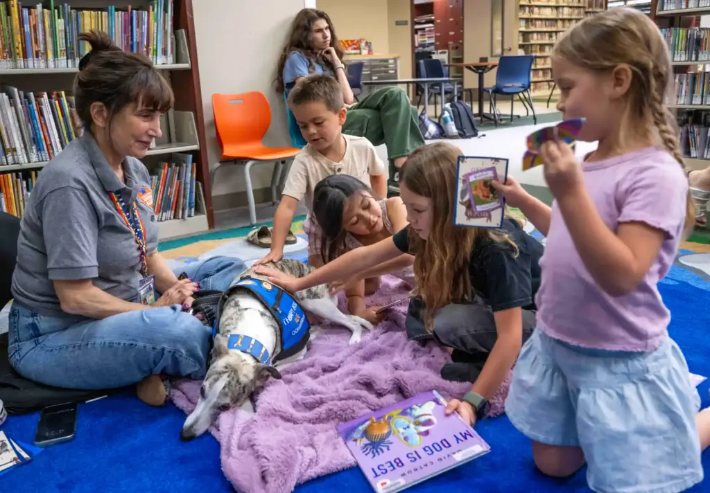 Kids read childrenâs books and give love to Alfie, a...