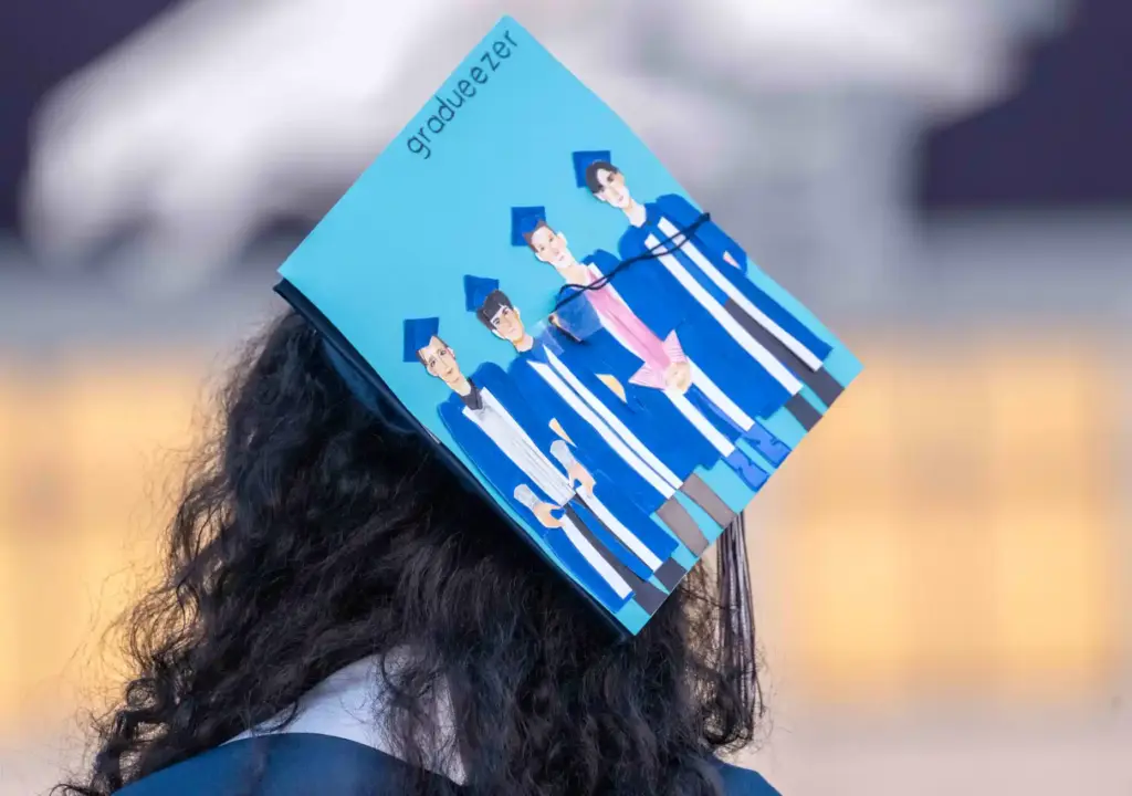 One graduate wears a customized cap paying homage to the...