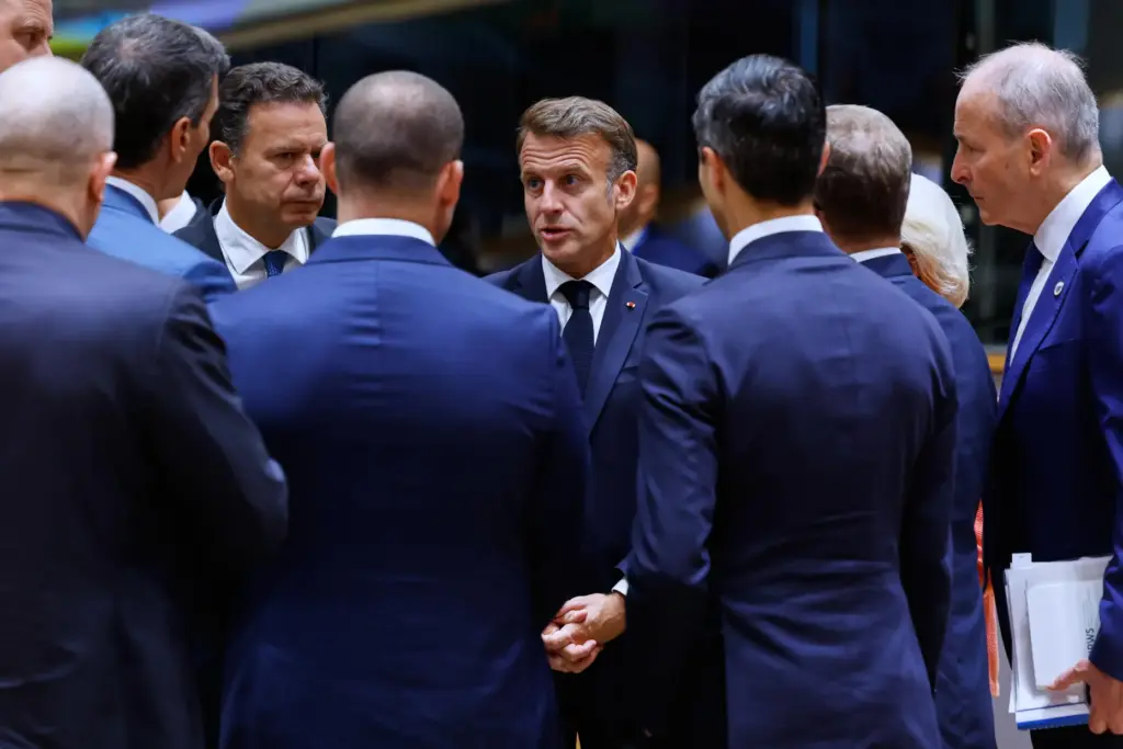 French President Emmanuel Macron, center, talks to other EU leaders...