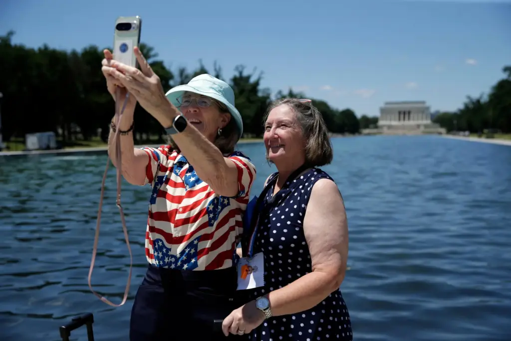 Visitors take a selfie at the Lincoln Memorial Reflecting Pool,...