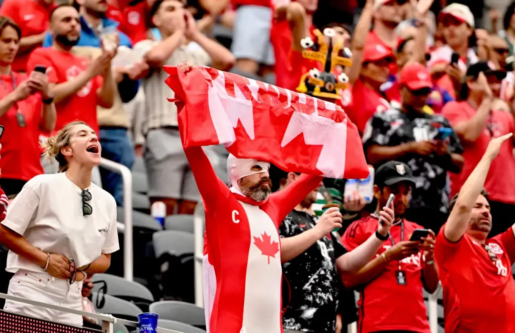 Canadian fans cheer as their team enters the pitch prior...