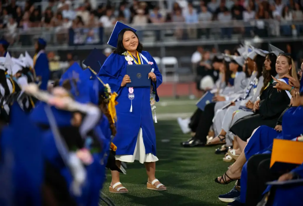 A graduate pauses to let a friend take her photo...