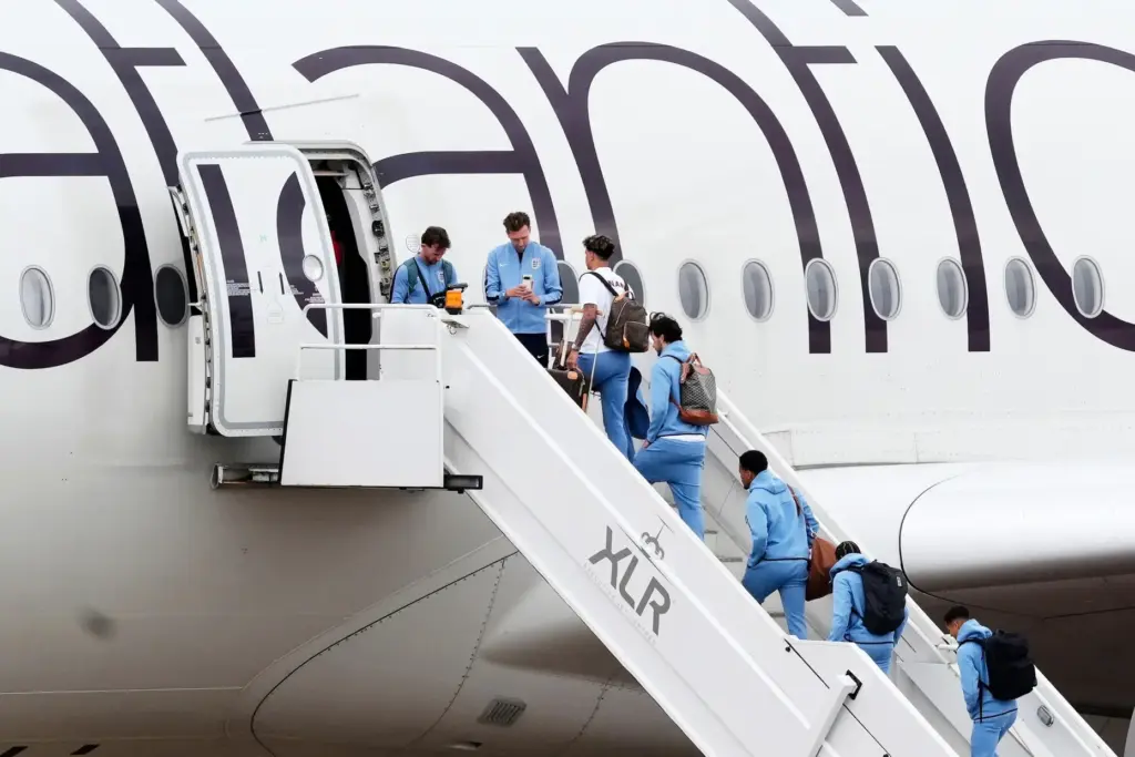 England goalkeeper James Trafford, fourth right and teammates board a...