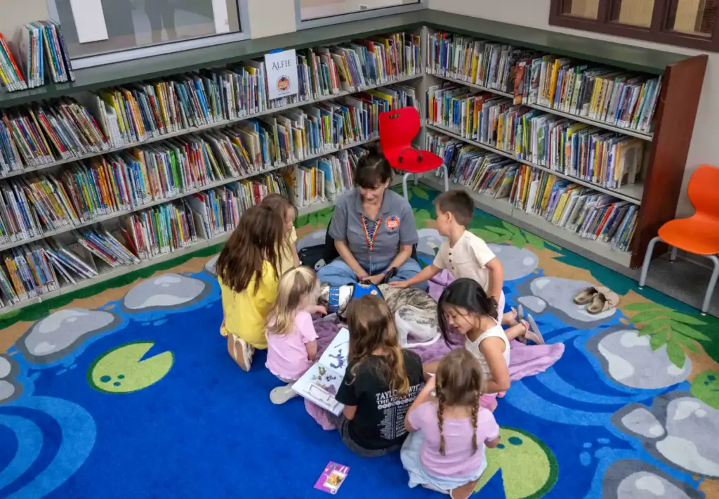 Kids read childrenâs books and give love to Alfie, a...