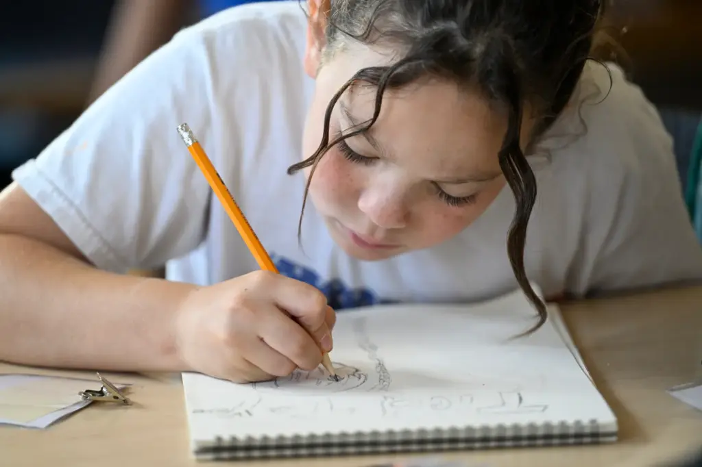 Riley Saunders works on artwork during âPublish Your Own Childrenâs...